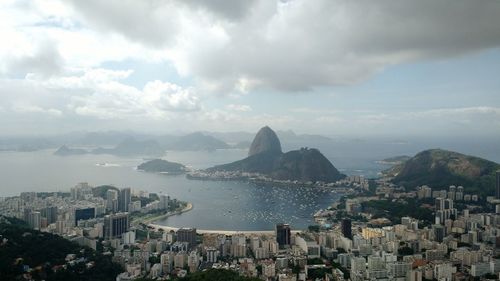 Panoramic view of city by sea against sky