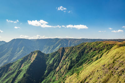 Misty mountain range covered with white mist and amazing blue sky