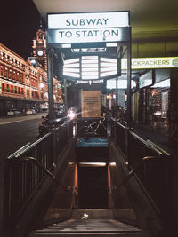 Illuminated railroad station platform at night
