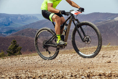 Athlete cyclist riding uphill on mountain bike