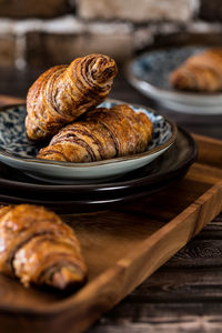 Close-up of chocolate croissant in plate on table