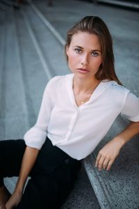 Portrait of businesswoman sitting on steps