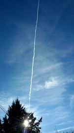 Low angle view of vapor trails against sky