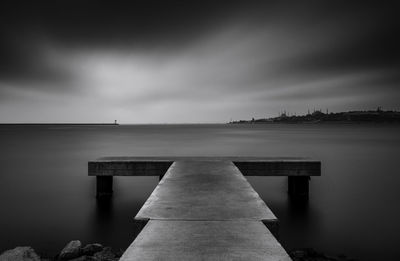 Pier over sea against sky