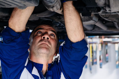 Close-up of man repairing vehicle