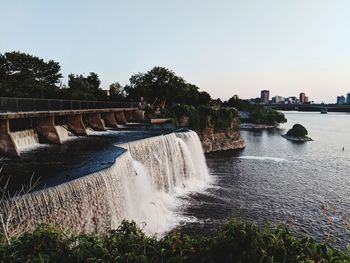 Scenic view of waterfall against clear sky