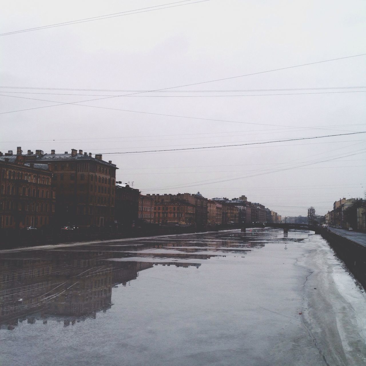 architecture, building exterior, built structure, water, city, river, waterfront, sky, connection, residential building, power line, residential structure, building, reflection, canal, outdoors, day, cable, house, bridge - man made structure