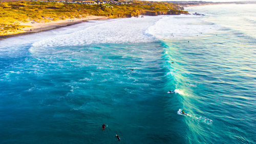 High angle view of people swimming in sea