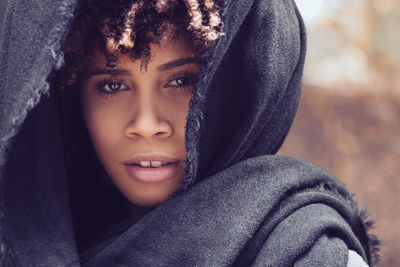 Close-up portrait of teenage girl wrapped in blanket