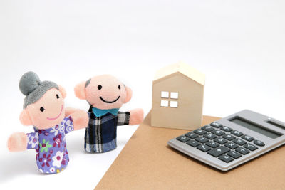 Close-up of toys on table against white background