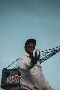 Low angle view of man standing against sky