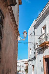 Low angle view of street light against building