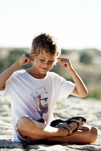 Boy sitting on beach