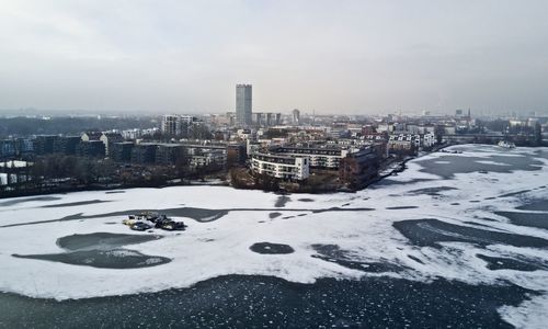 Snow covered cityscape against sky