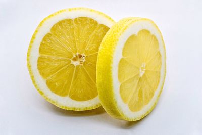 Close-up of lemon slice against white background