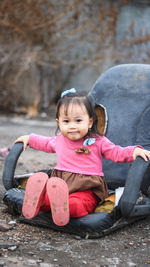 Portrait of cute girl sitting outdoors