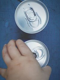 Cropped image of hand holding drink can