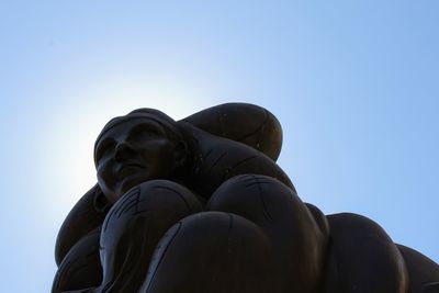 Low angle view of statue against clear blue sky