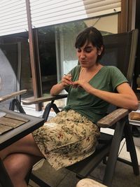 Woman sitting on chair at home