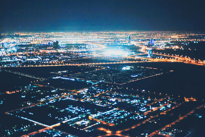 High angle view of illuminated buildings in city at night