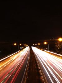 High angle view of light trails on road at night