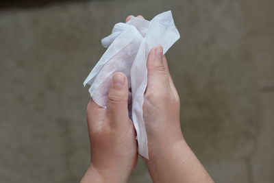 Cropped hands holding tissue paper