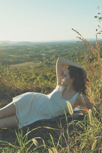 Woman standing on grassy field