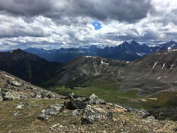 Scenic view of mountains against cloudy sky