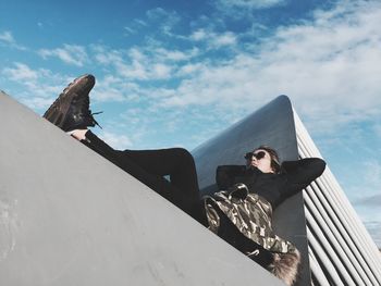 Man sitting on boat against sky