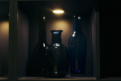 Close-up of bottles in illuminated shelf