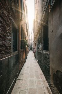 Empty footpath amidst old building