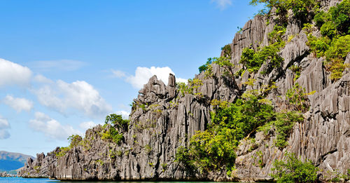 Low angle view of rock formations against sky