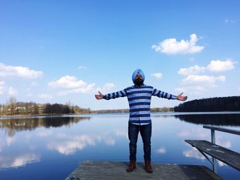 Full length of man standing on pier against lake