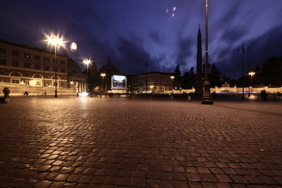 Illuminated city against sky at night