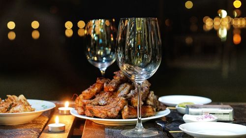 Close-up of food served with wine on table