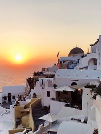 Buildings in city during sunset