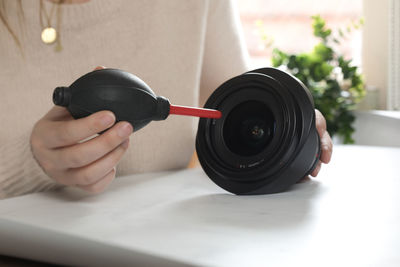 Cropped hand of man holding equipment