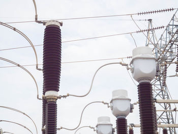 Low angle view of electricity pylon against sky