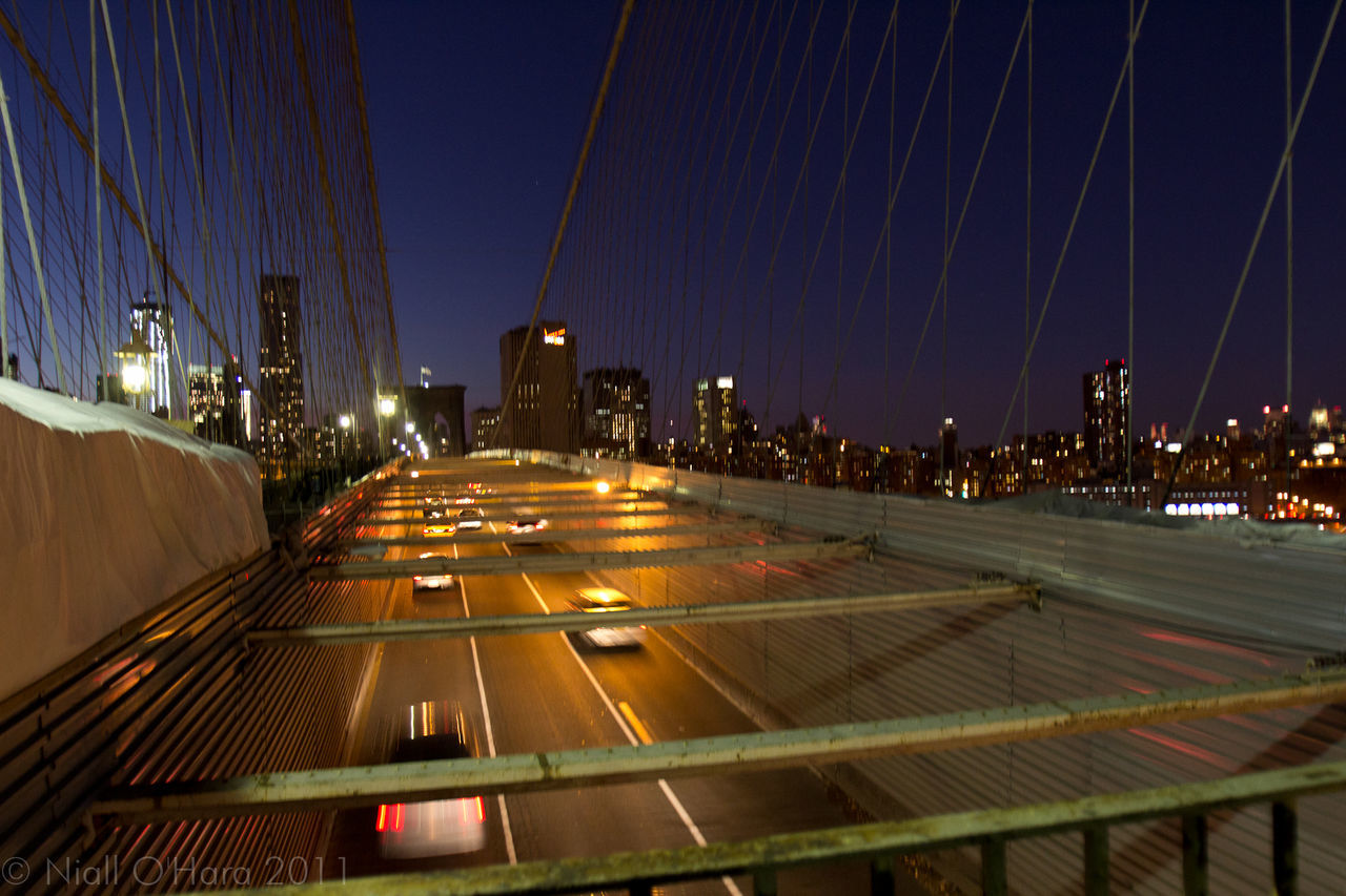 LIGHT TRAILS ON STREET AT NIGHT