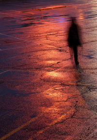 Shadow of person walking on street