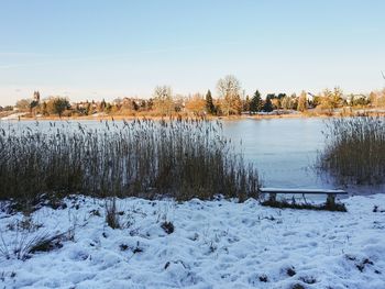 Scenic view of frozen lake against sky during winter