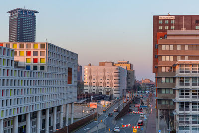 Buildings in city against clear sky