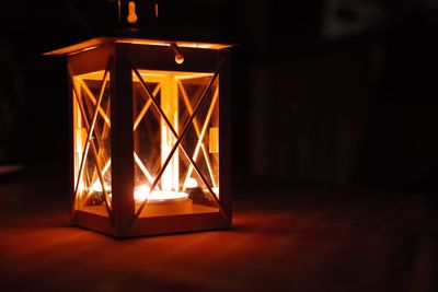 Close-up of illuminated lamp in dark room