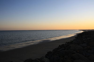 Scenic view of sea against clear sky during sunset