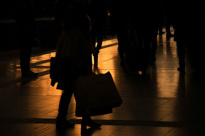 Low section of woman walking in corridor