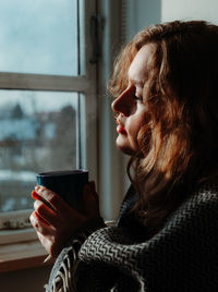 Woman drinking coffee in cup