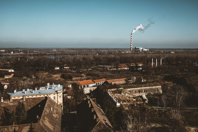 Aerial view of buildings in town against sky