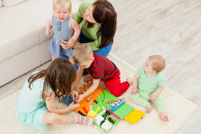 High angle view of children playing with toy