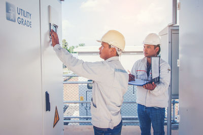 Two men with work helmet working