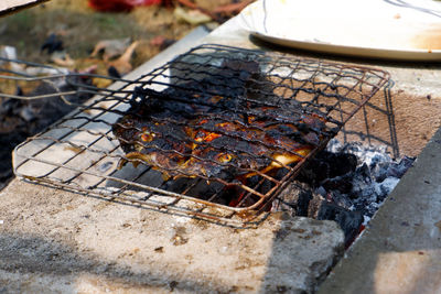 High angle view of meat on barbecue grill